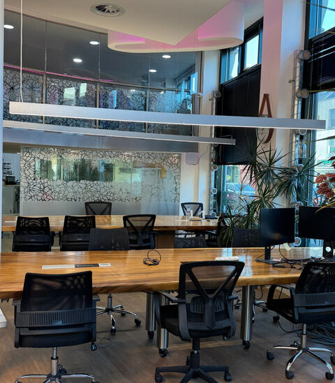 Open-plan desks below a glazed mezzanine at Camden Gateway