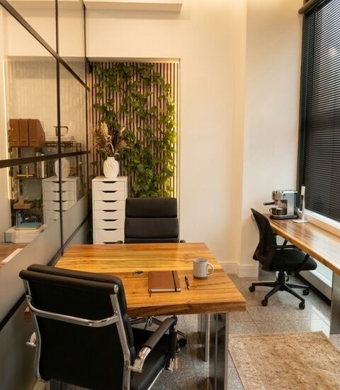 Private office at Camden Gateway with a plant wall, desks and office chairs