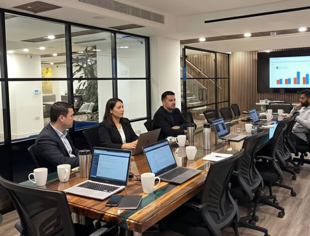 Glass-walled meeting room in use at Camden Gateway