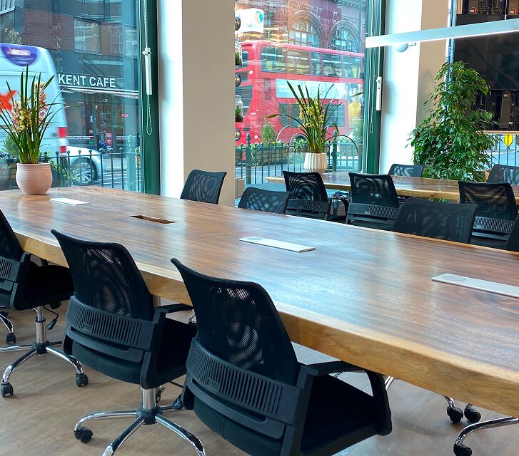 Long boardroom table and chairs in a meeting space at Camden Gateway