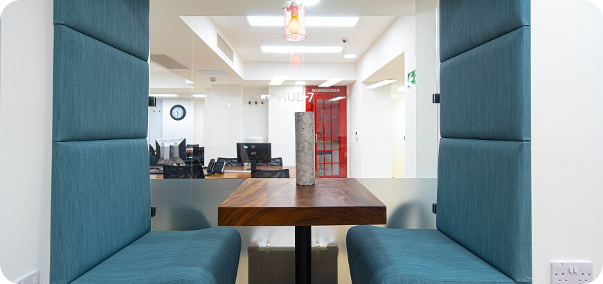 Upholstered calling pod booth with a table at Camden Gateway
