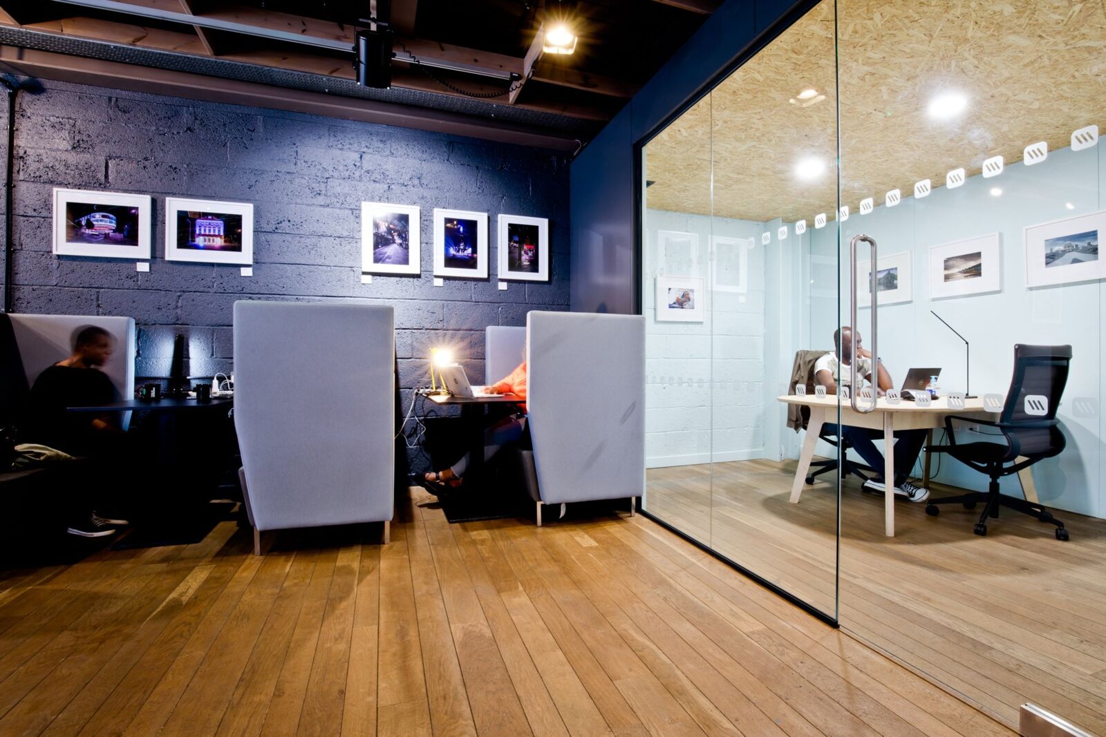 Interior of a modern office with a glass-walled meeting room