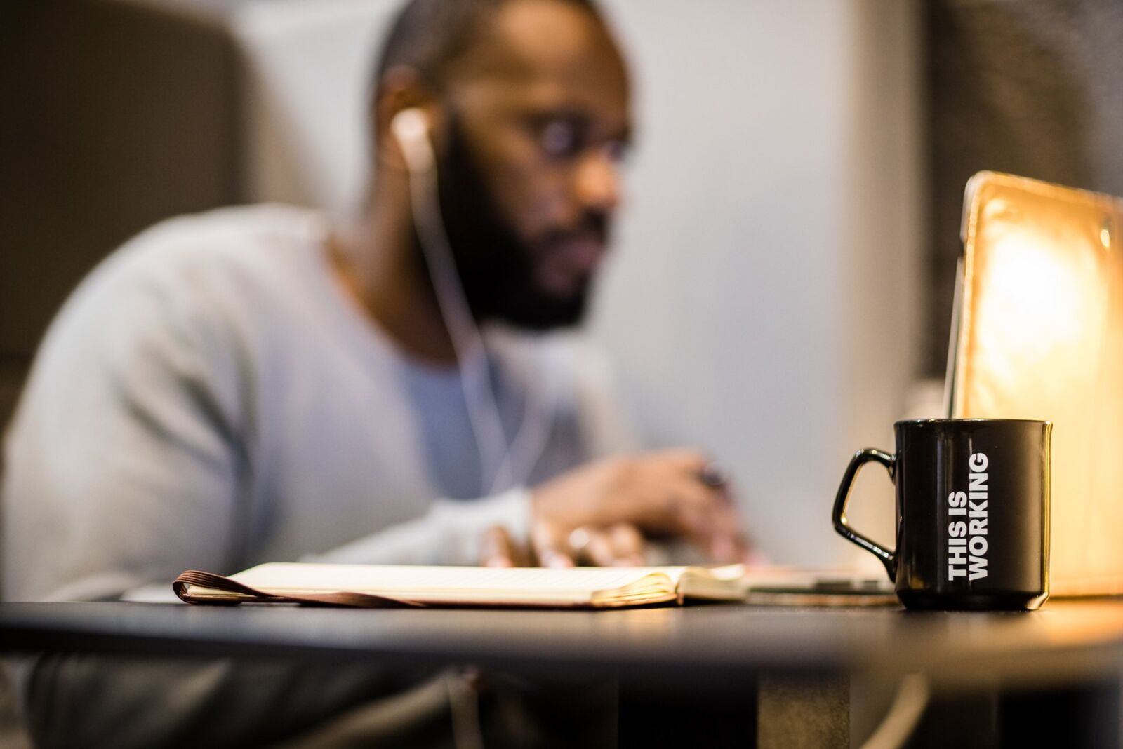 A man sitting at a desk, working on a computer