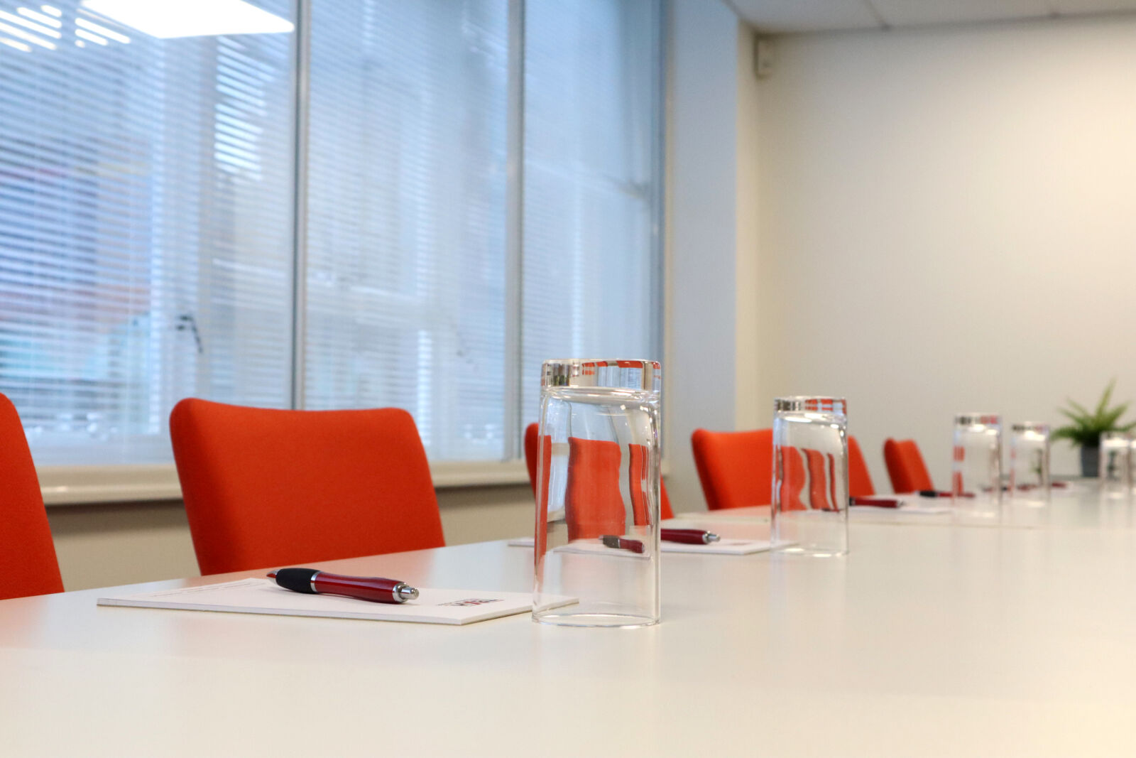 Meeting table set with glasses and notepads at TBXH