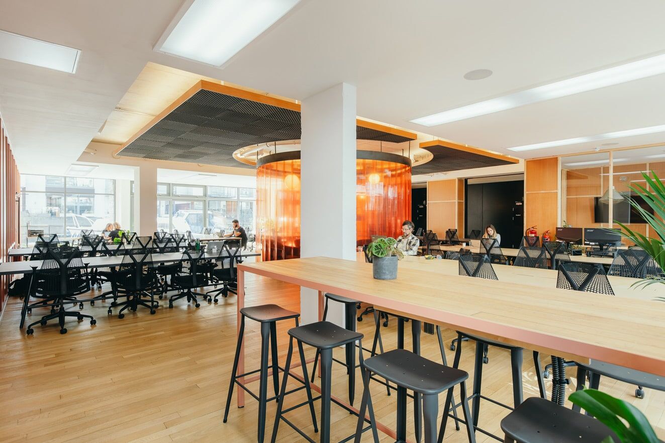 Bar-height bench seating and desks along the windows at The Halley