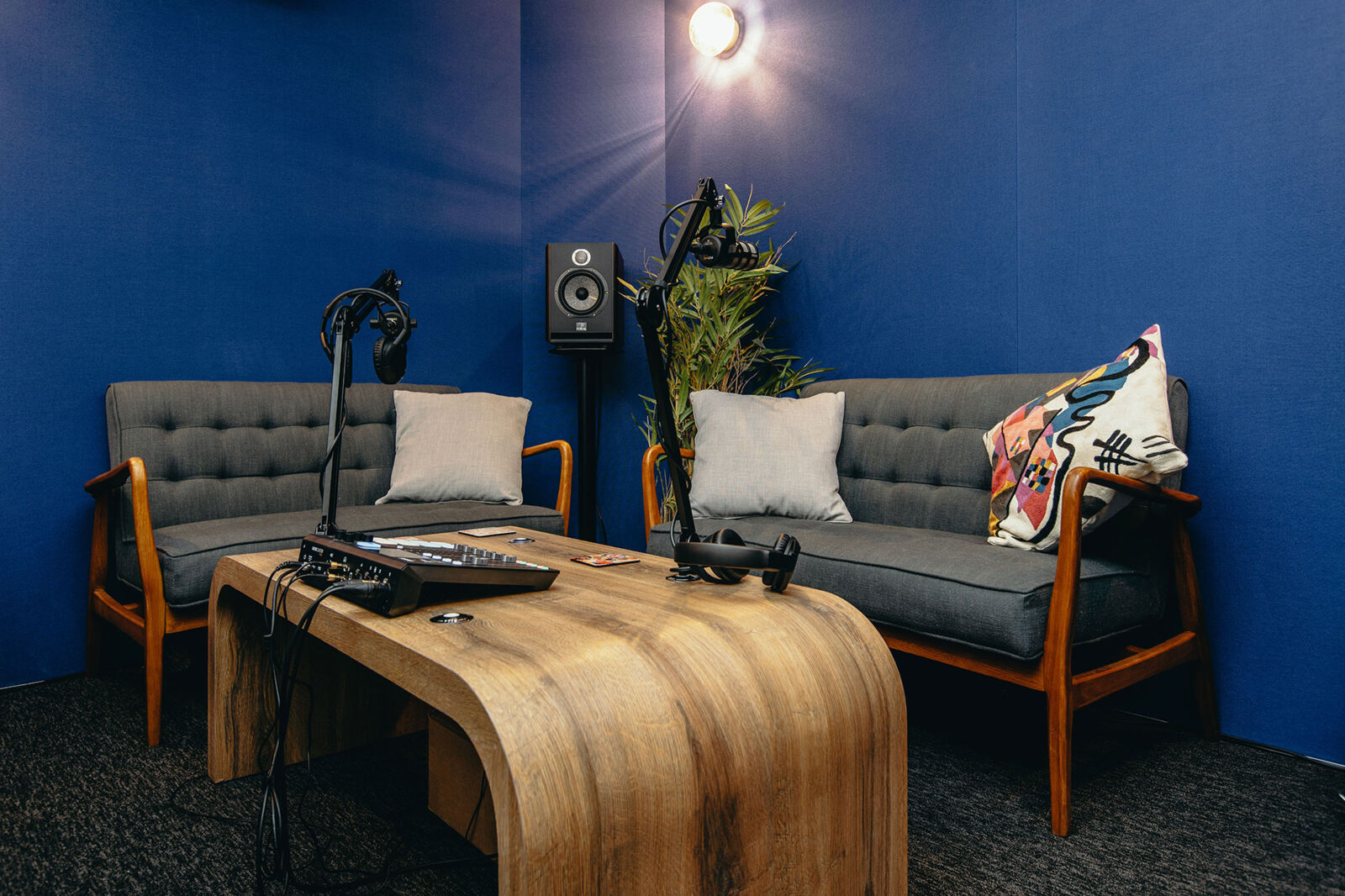 Podcast Suite (Studio 2) at The Halley with a sofa, microphones and a wooden coffee table