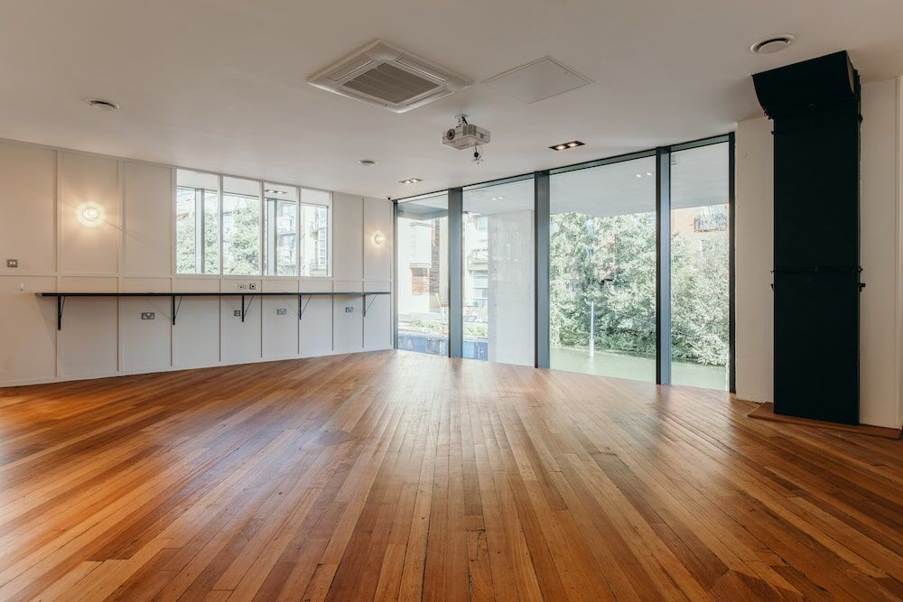 Wooden-floored Gallery event space at The Halley overlooking Kingsland Basin