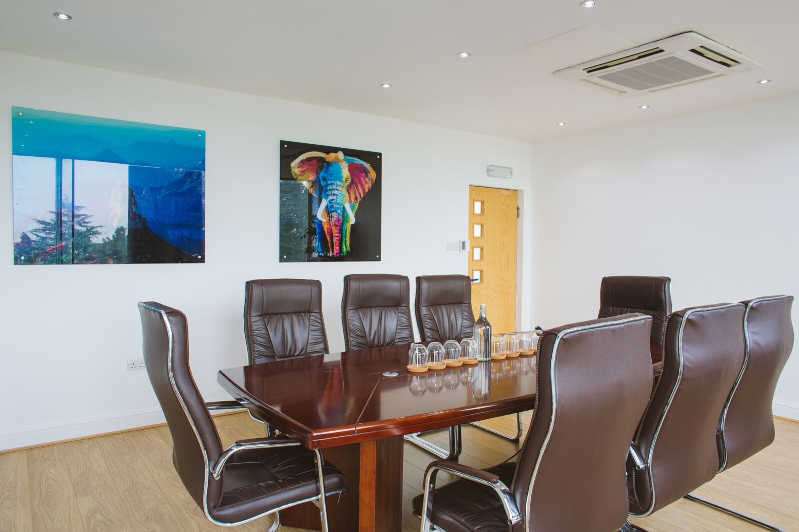 Meeting room at Vista Centre with a boardroom table and leather chairs